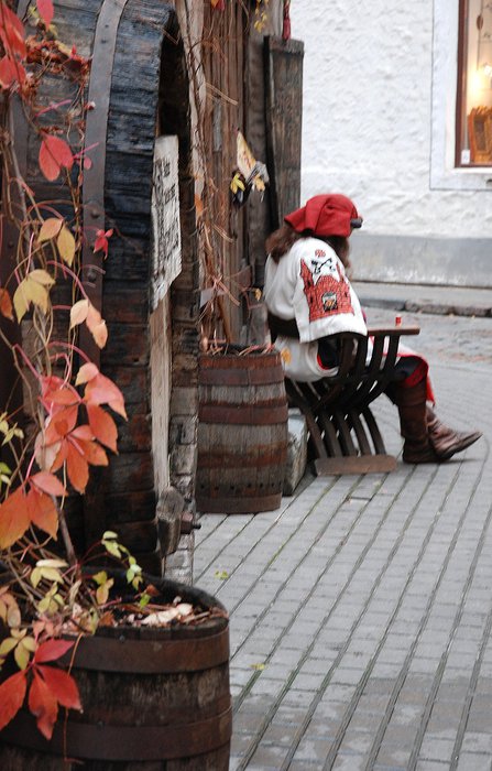 вход рядом с местом, где сидит нарядный мужичок Рига, Латвия