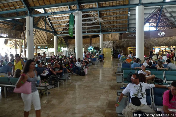 Так выглядит зал ожидания. Чуть-чуть дьютифри, одна палатка с пивом и скамейки под крышей из банановых листьев. Пунта-Кана, Доминиканская Республика