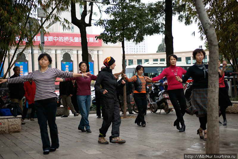 Китайцы любят танцевать в парках. Эти женщины знают связки наизусть, сложно с ходу попасть в ритм. Танцуют, кстати, под Отпетых мошенников Куньмин, Китай