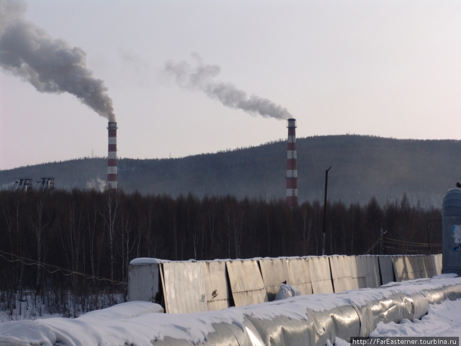 Трубы электростанции задымляют зимнее небо над Тындой Тында, Россия